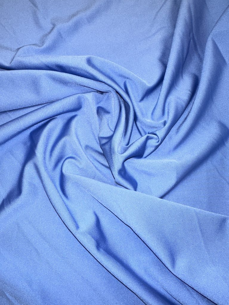 Elegant Jersey Satinée fabric with a smooth, shiny surface for luxurious garments.