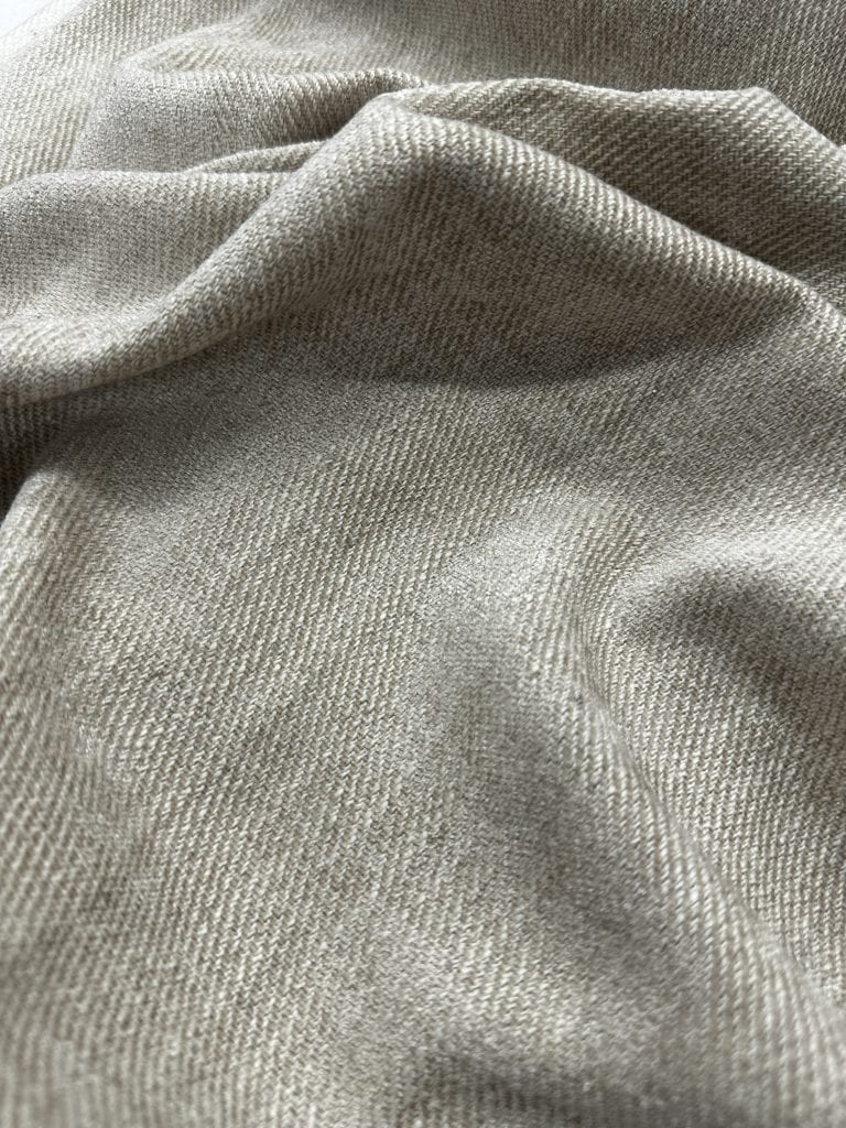 Elegant beige curtain fabric for home decor and window treatments.