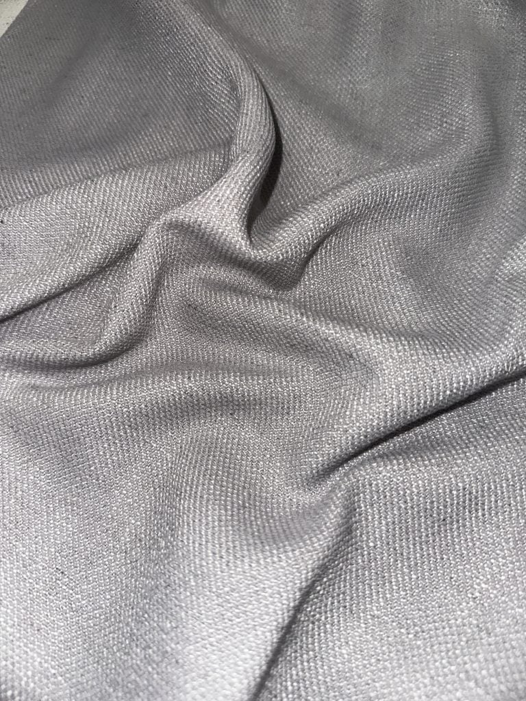 Elegant silver curtain fabric for stylish window treatments.