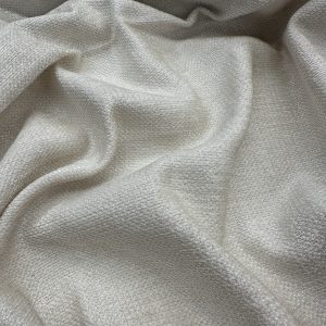 Elegant cream-colored fabric with a smooth texture, ideal for upholstery, drapery, and textile proje.