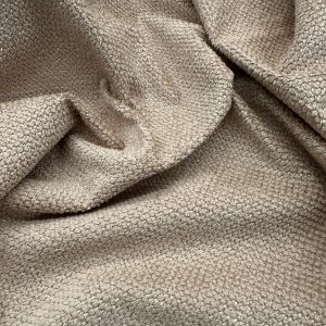 Beige textured fabric close-up, ideal for upholstery, fashion, and interior design projects. High-qu.