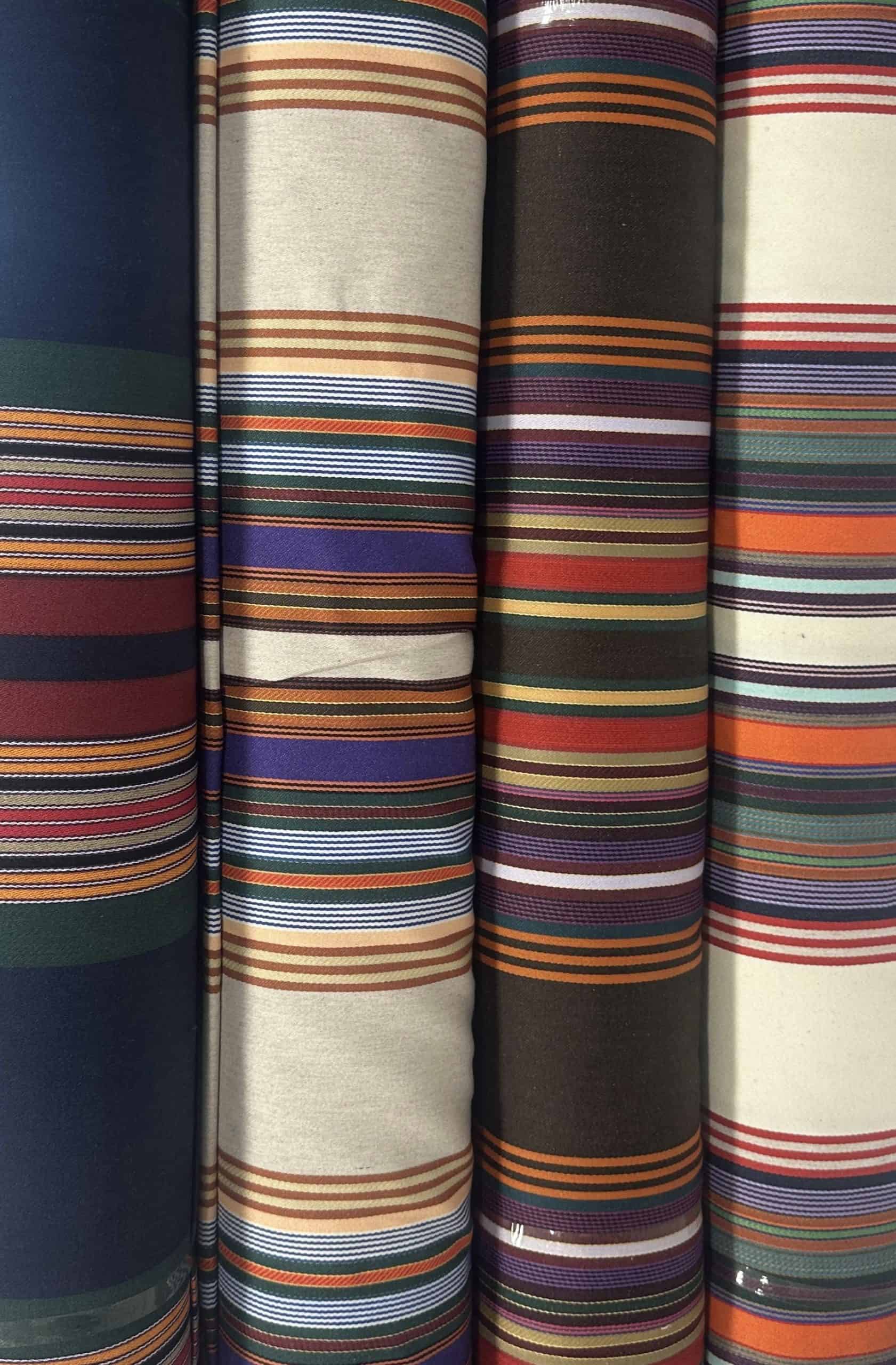 Assorted striped fabrics showcasing vibrant colors and patterns for textiles and fashion.
