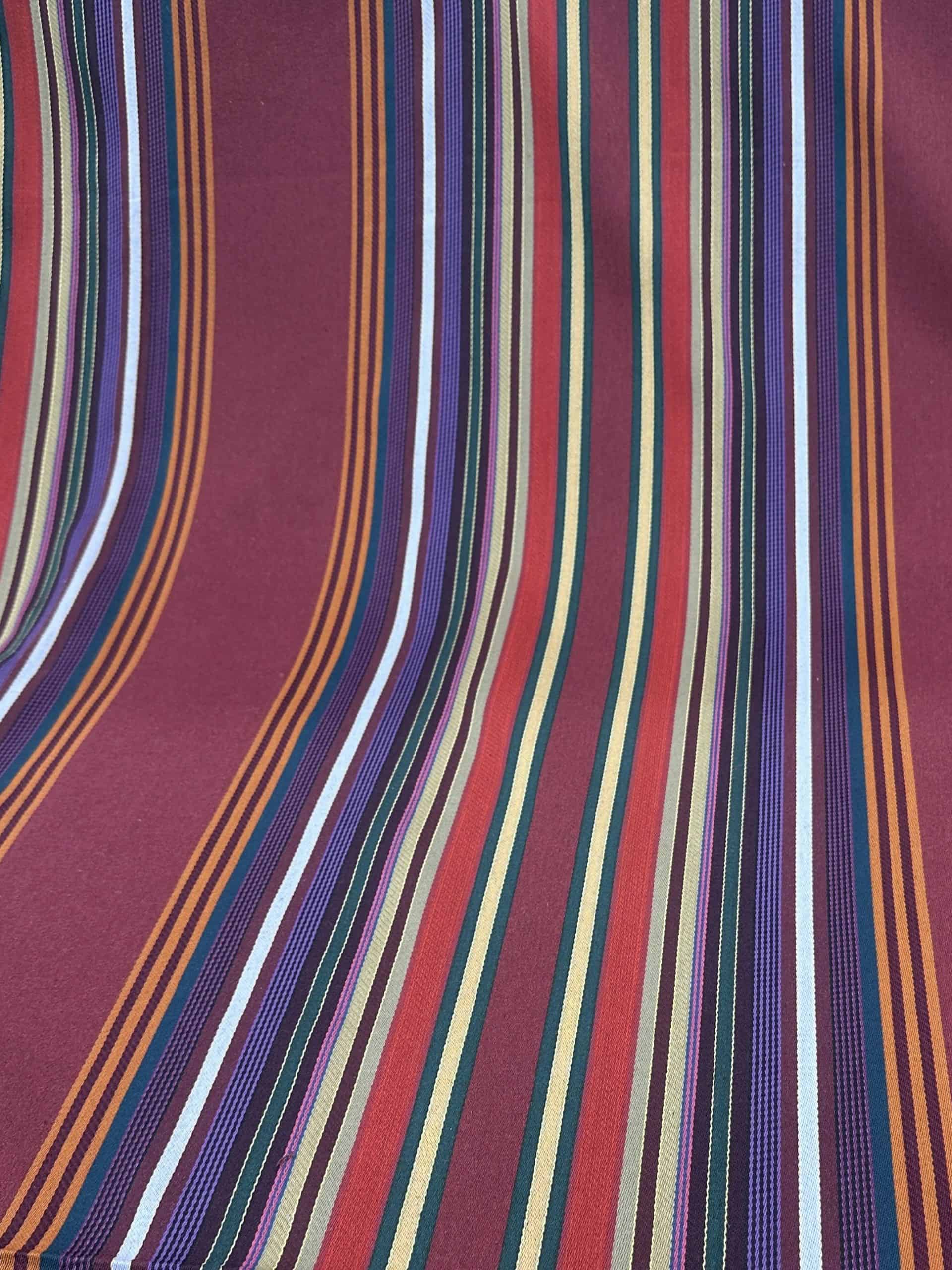 Vibrant striped textile fabric showcasing multiple colors and patterns.