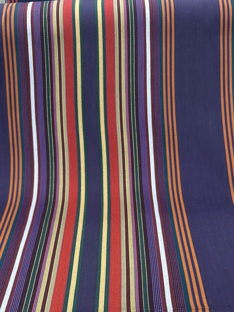 Vibrant striped textile fabric showcasing multiple colors and patterns.