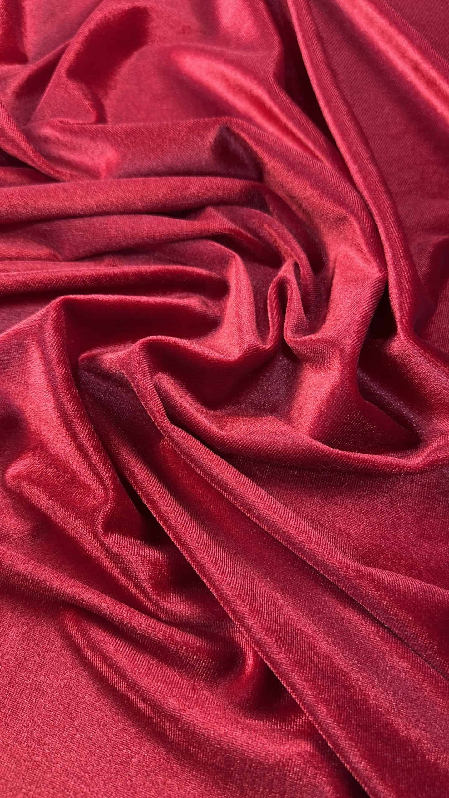 Red velvet spandex fabric with smooth, luxurious texture and vibrant color.
