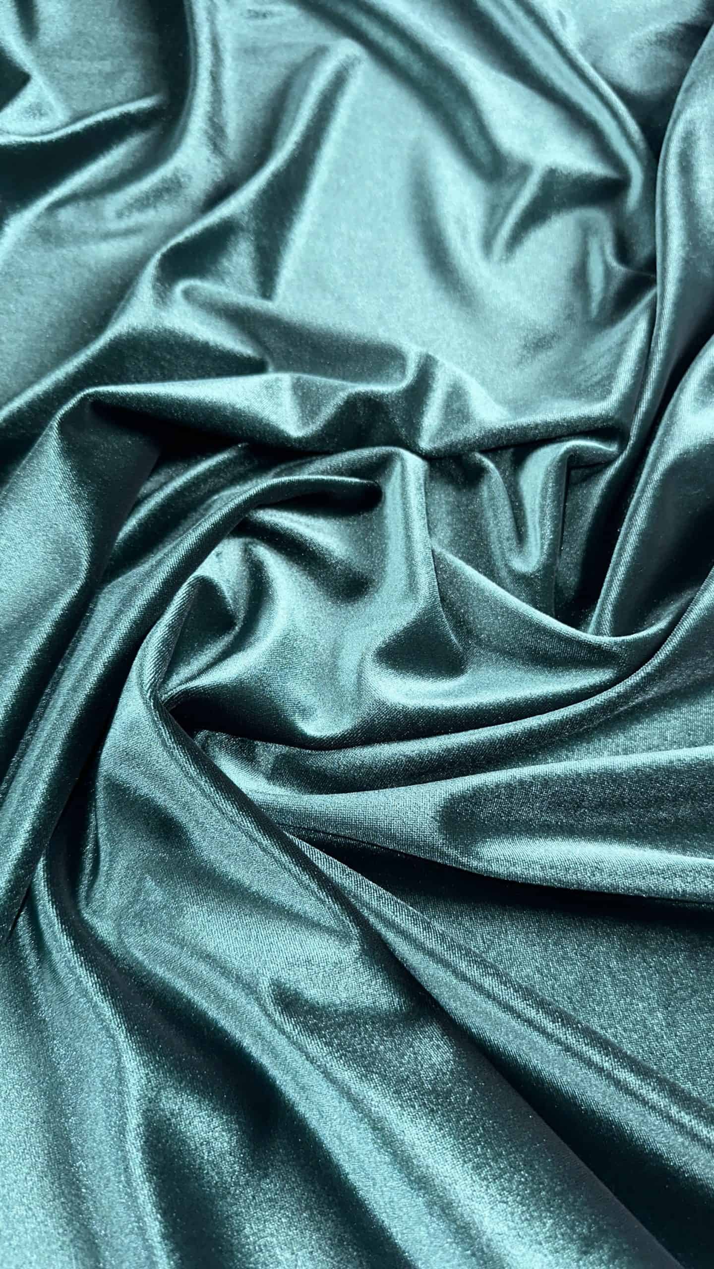 Luxurious teal velvet spandex heavyweight fabric for upholstery and fashion.
