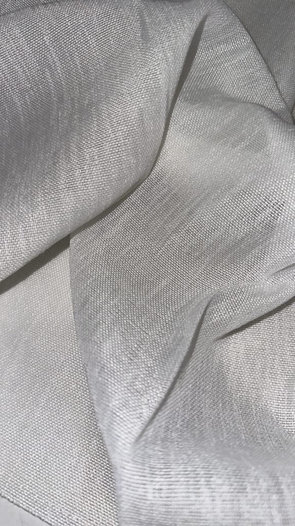 Close-up of silver woven fabric showcasing fine texture and sheen.